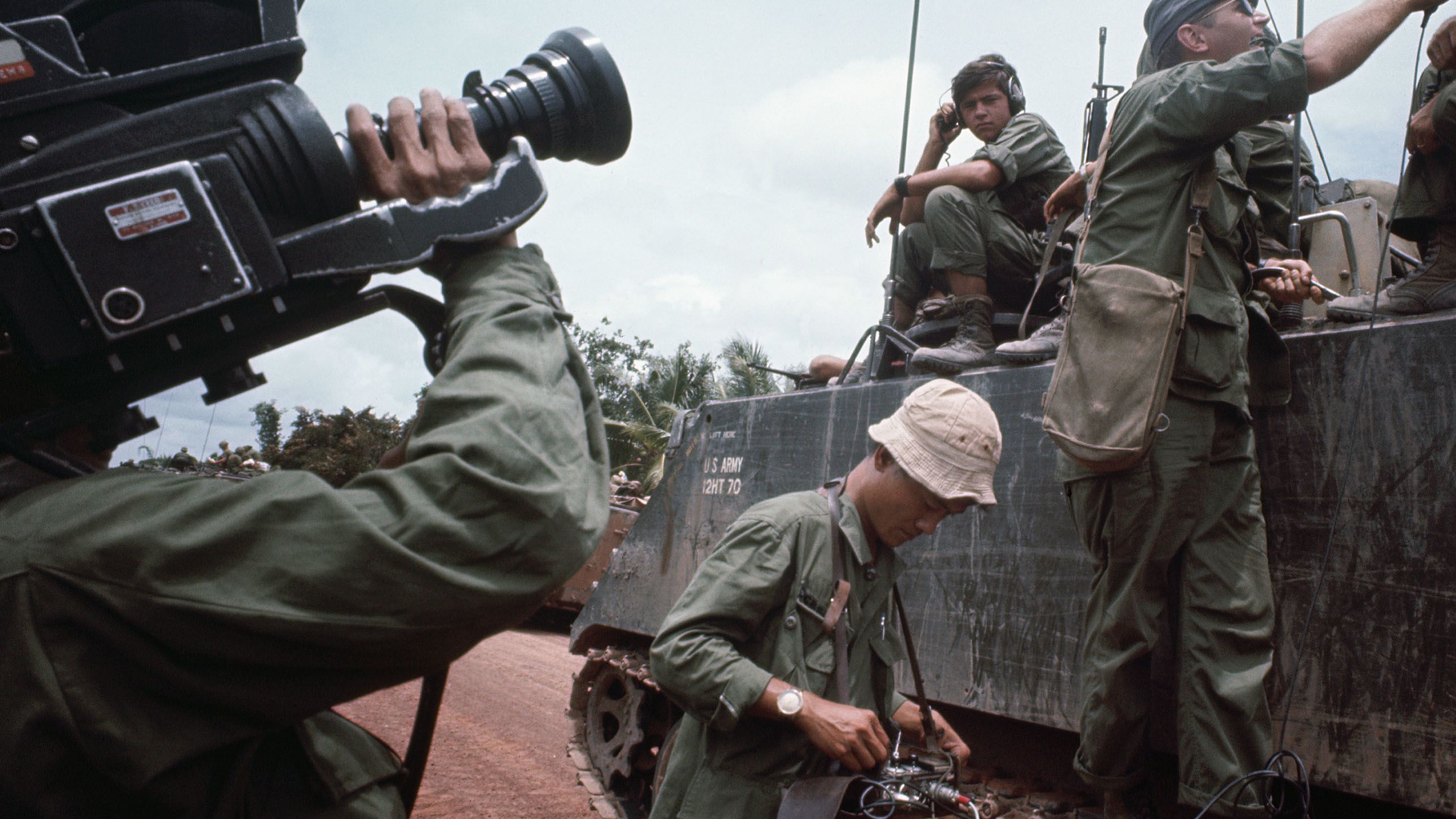 A CBS TV crew at work. Journalists were allowed to tag along with the troops as far as they dared, and correspondents were given the nominal rank of major. (Tim Page/Getty Images)