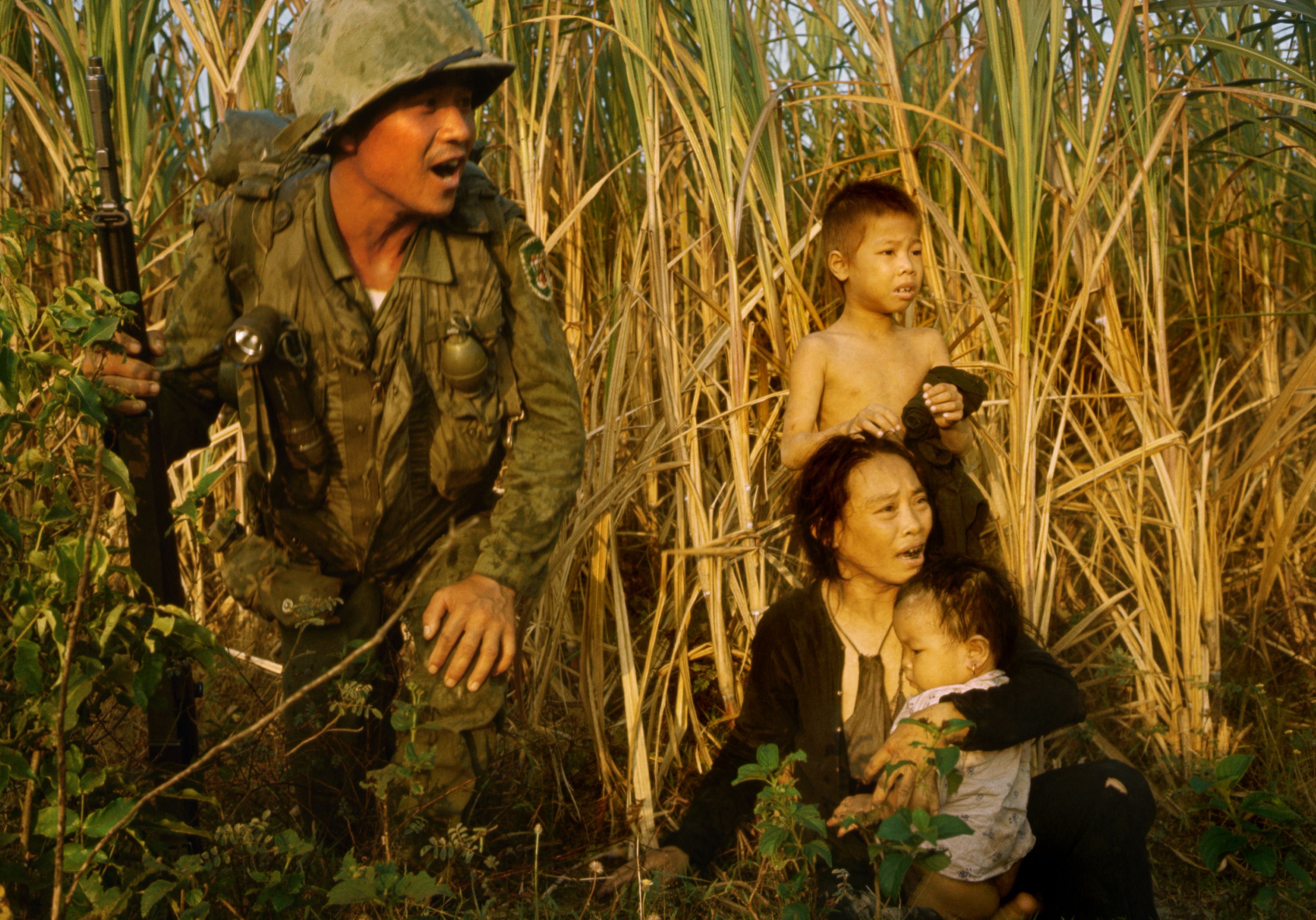 South Korean soldier with a terrified Vietnamese family. Koreans were among the most feared combatants in Vietnam. (Tim Page/Getty Images)